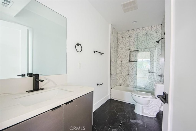 full bathroom featuring tiled shower / bath, vanity, toilet, and tile patterned flooring