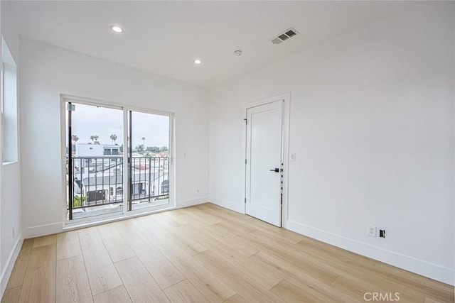 spare room featuring light wood-type flooring