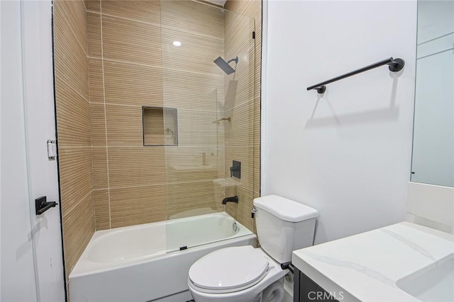 full bathroom with vanity, tiled shower / bath combo, and toilet