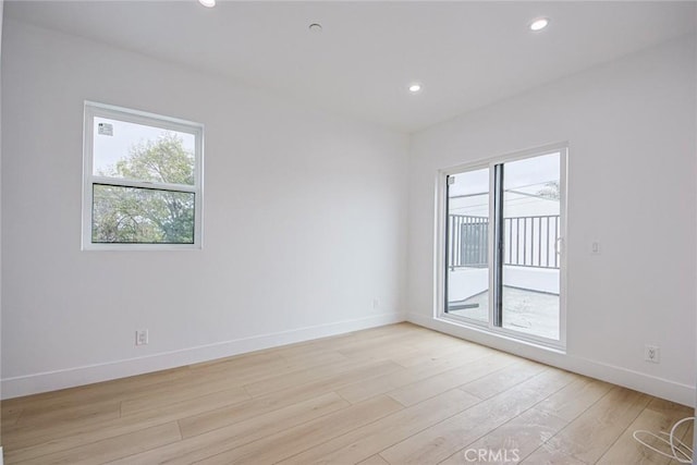 unfurnished room with light wood-type flooring