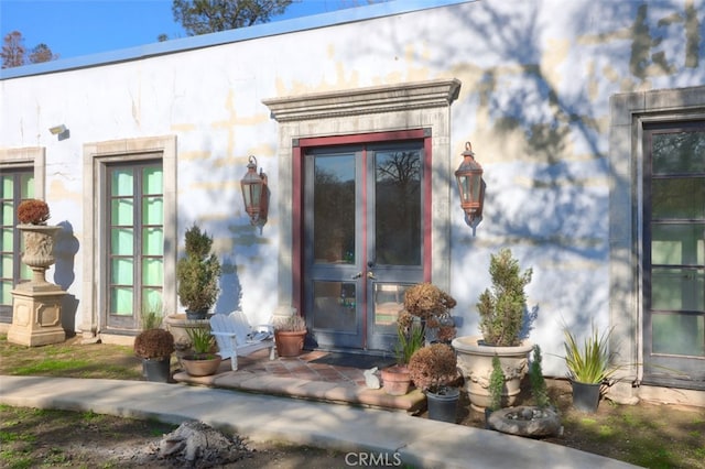 view of exterior entry featuring french doors