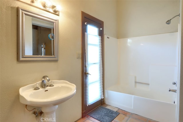 bathroom featuring tile patterned flooring, sink, and shower / tub combination