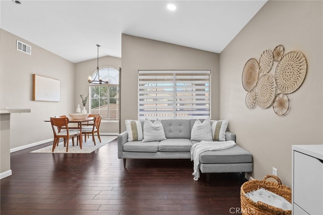 living room with lofted ceiling, dark hardwood / wood-style flooring, and a chandelier