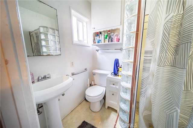 bathroom featuring sink, toilet, and a shower with shower curtain