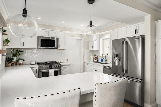 kitchen featuring high quality appliances, hanging light fixtures, white cabinets, and kitchen peninsula