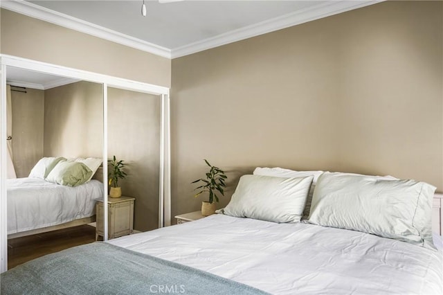 bedroom featuring ornamental molding and a closet