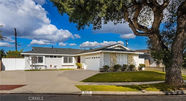 single story home featuring a garage and a front yard