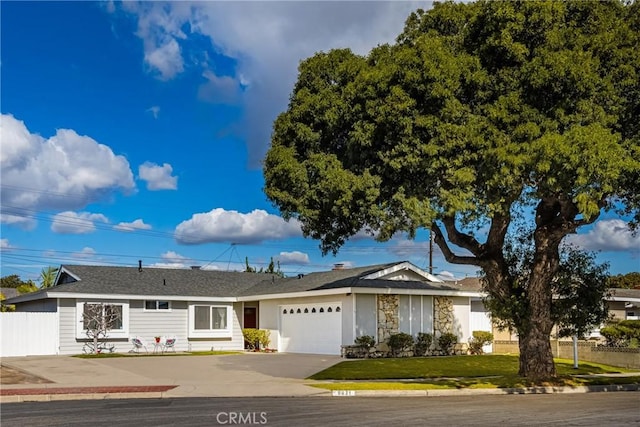 single story home with a garage and a front lawn