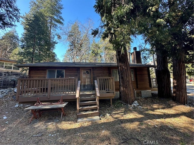 back of house featuring a wooden deck