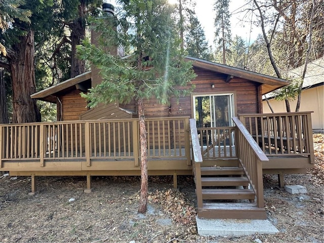 rear view of property featuring a deck