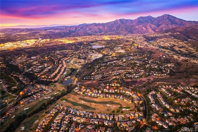 aerial view at dusk featuring a mountain view