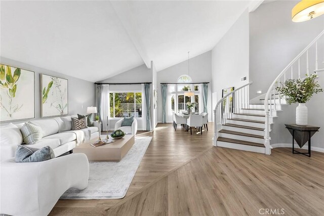 living room featuring hardwood / wood-style flooring and high vaulted ceiling