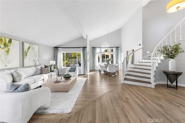 living room with wood-type flooring and high vaulted ceiling