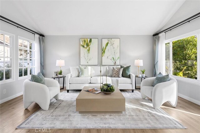 living room with lofted ceiling and light hardwood / wood-style floors