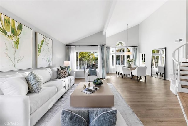 living room featuring high vaulted ceiling and hardwood / wood-style floors