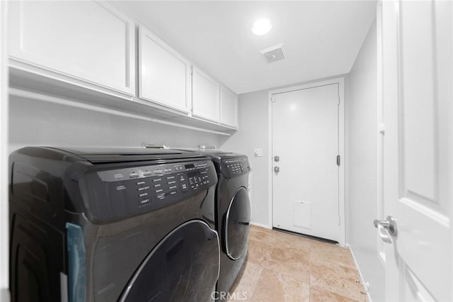 washroom with cabinets and separate washer and dryer