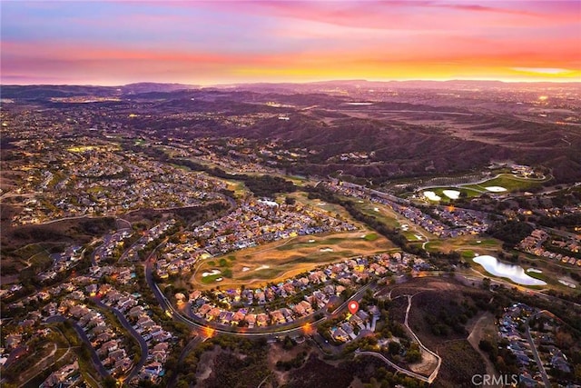 aerial view at dusk featuring a mountain view