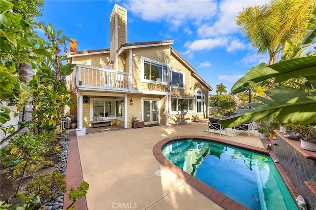 back of property featuring a patio and a balcony