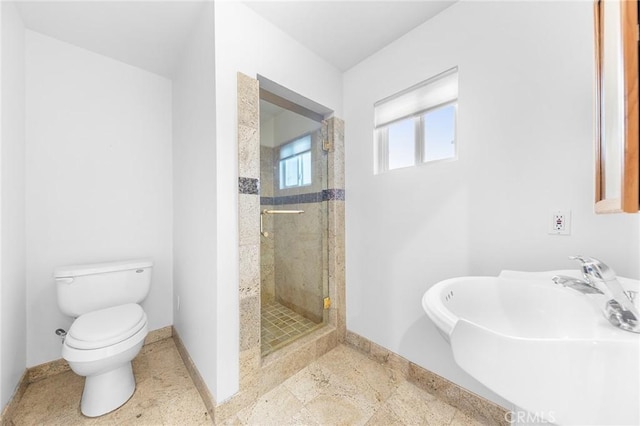 bathroom with toilet, an enclosed shower, and sink