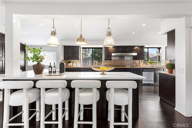 kitchen with tasteful backsplash, a kitchen bar, and a kitchen island