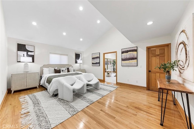 bedroom with lofted ceiling and light wood-type flooring