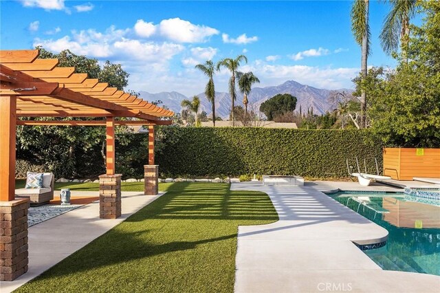 exterior space featuring a pergola, a swimming pool, a patio, and a mountain view