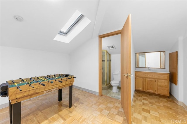 recreation room featuring lofted ceiling with skylight, sink, and light parquet floors