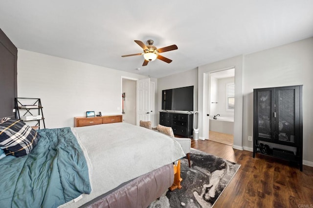 bedroom featuring dark hardwood / wood-style flooring, ceiling fan, and ensuite bathroom