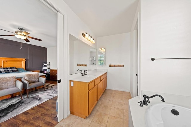 bathroom featuring vanity, a bath, tile patterned floors, and ceiling fan