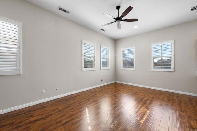 empty room with dark wood-type flooring and ceiling fan