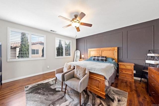 bedroom with ceiling fan and dark hardwood / wood-style flooring