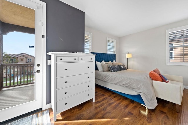 bedroom featuring dark hardwood / wood-style flooring and access to outside