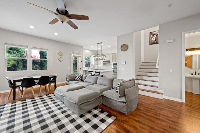 living room featuring hardwood / wood-style floors and ceiling fan