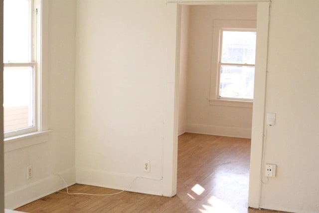 unfurnished room with plenty of natural light and light hardwood / wood-style floors