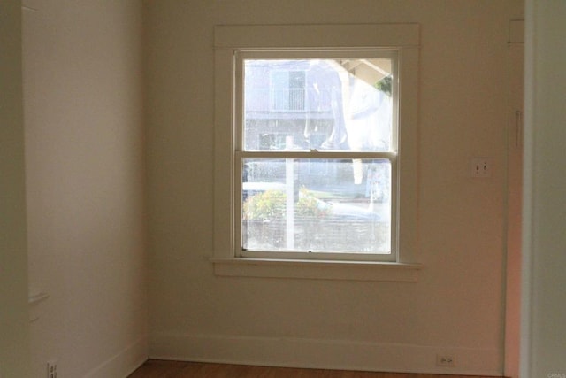 unfurnished room with wood-type flooring and plenty of natural light