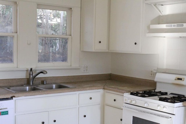 kitchen featuring dishwasher, white range with gas cooktop, sink, and white cabinets