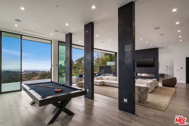 rec room with expansive windows, pool table, and hardwood / wood-style floors