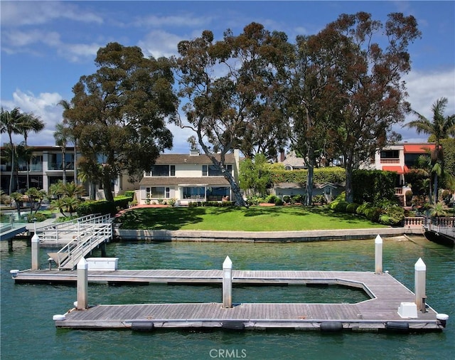 dock area with a water view and a lawn