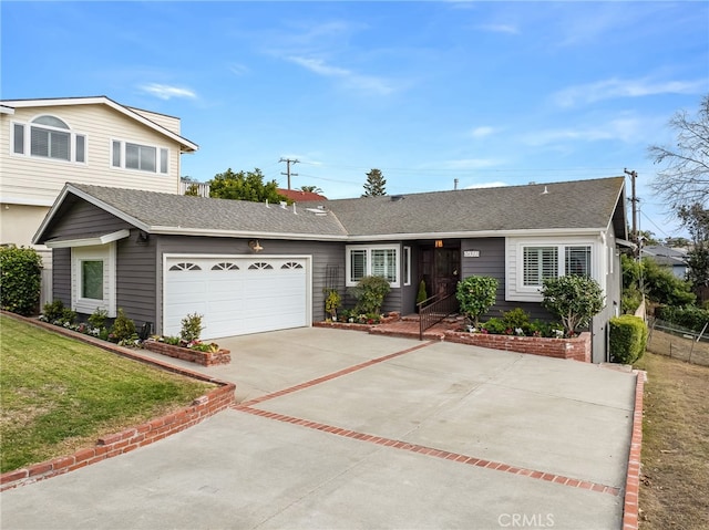 view of front of property with a garage and a front lawn