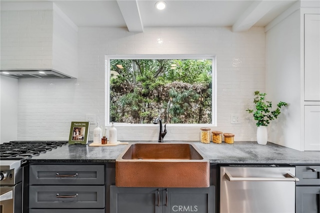 kitchen featuring sink, beam ceiling, custom exhaust hood, and backsplash