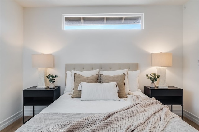 bedroom featuring dark hardwood / wood-style flooring and multiple windows