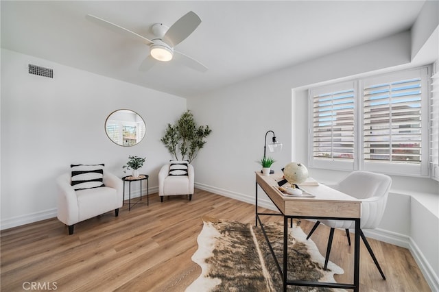 home office with ceiling fan and light wood-type flooring