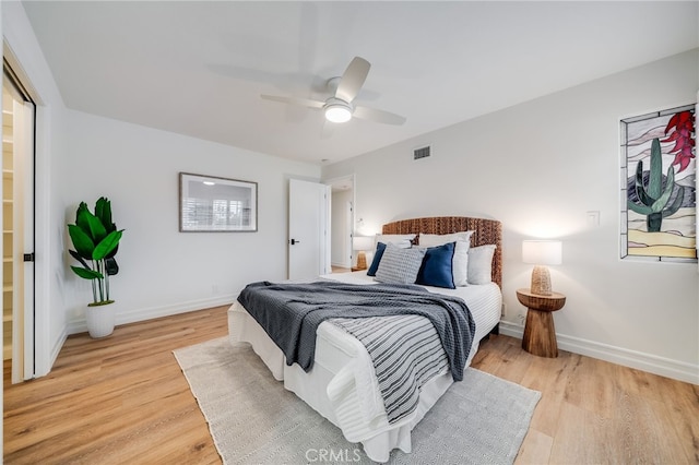 bedroom with ceiling fan and light hardwood / wood-style floors