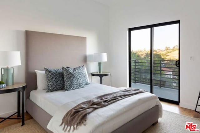 bedroom featuring light hardwood / wood-style flooring and access to outside