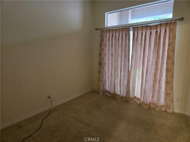 carpeted empty room featuring a healthy amount of sunlight