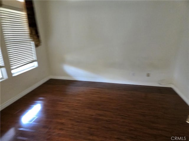 spare room featuring dark hardwood / wood-style flooring