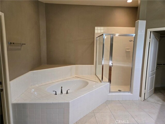 bathroom featuring tile patterned floors and plus walk in shower