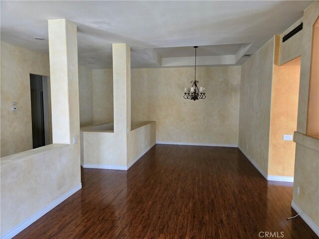 unfurnished dining area featuring dark hardwood / wood-style flooring, elevator, and an inviting chandelier