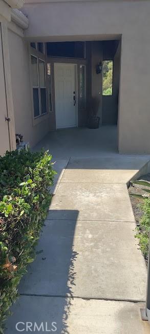 doorway to property featuring an AC wall unit