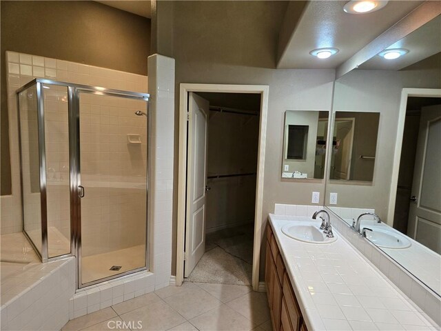 bathroom featuring an enclosed shower, vanity, and tile patterned flooring